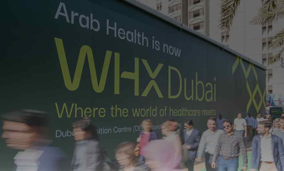 WHX Dubai on signboard with attendees walking by