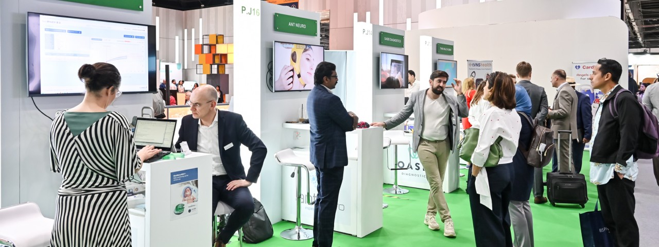 Several exhibitors from the event in small booths, called pods, attending to their visitors